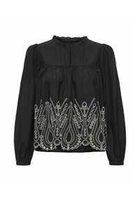 Blouse noire à manches longues, avec un décolleté volé et une broderie blanche complexe en motif floral le long de l'ourlet inférieur.