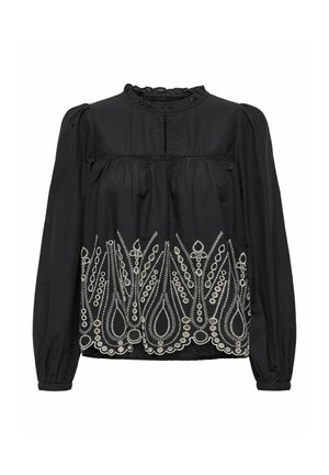 Blouse noire à manches longues, avec un décolleté volé et une broderie blanche complexe en motif floral le long de l'ourlet inférieur.