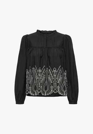 Blouse noire à manches longues, avec un décolleté volé et une broderie blanche complexe en motif floral le long de l'ourlet inférieur.