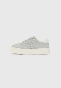 Light gray suede sneaker with white sole, gray side stripes, white heel patch, and gray laces on plain white background.