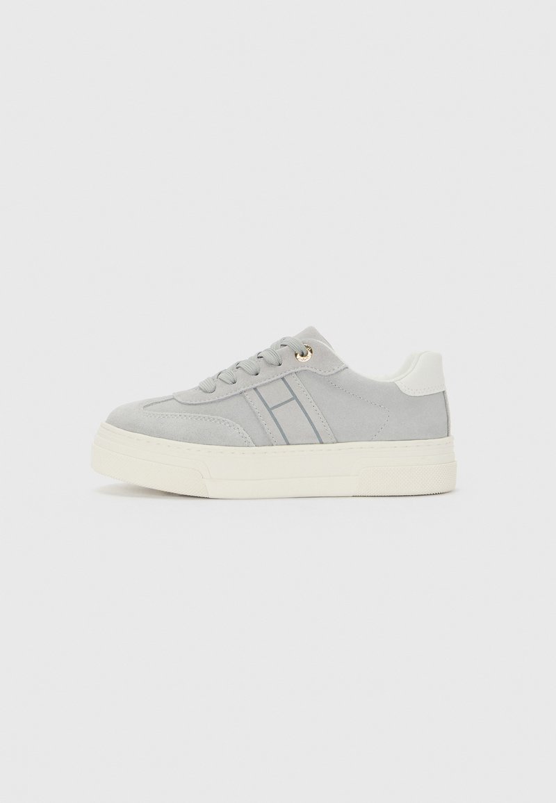 Light gray suede sneaker with white sole, gray side stripes, white heel patch, and gray laces on plain white background.