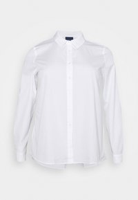 Vitt långärmad skjorta gjord av mjuk bomull. Har en knappstängning framtill, klassisk krage och sidofickor vid fållarna för en avslappnad passform.