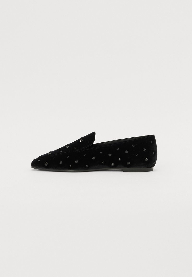 Black velvet slip-on shoes with a pointed toe, featuring textured accents and raised black studs across the upper surface.