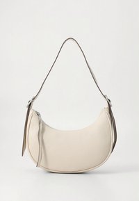 Cream-colored crescent-shaped leather handbag with a single strap and a zipper closure with a pull tab on a white background.