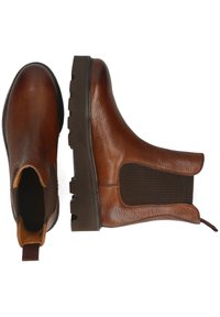 Bottes Chelsea en cuir marron avec des semelles en caoutchouc épaisses, des panneaux latéraux élastiques et des languettes, visibles de haut et de côté sur un fond blanc.