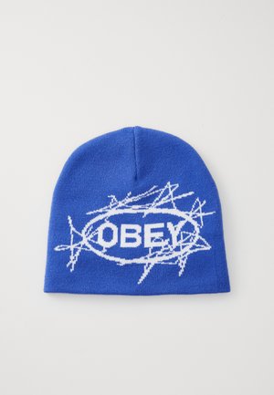 Blue knit beanie featuring a white graphic design with the word "OBEY" inside an oval, accented by jagged lines. Soft texture.