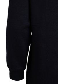 Black sweatshirt fabric shows a close-up of the sleeve, featuring a ribbed cuff and smooth texture, with minimal stitching details.