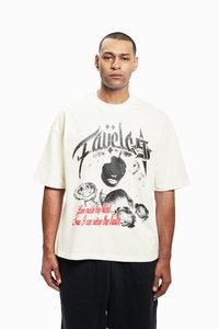 Cream oversized t-shirt with graphic print featuring a face, roses, and text in red and black. Short sleeves, round neckline, cotton material.