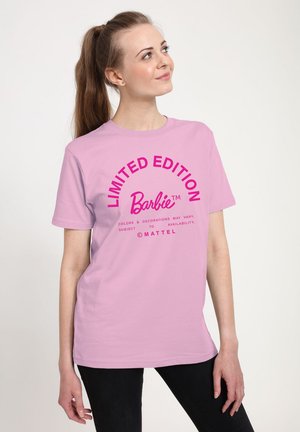 Pink short-sleeve t-shirt featuring "LIMITED EDITION" and "Barbie™" in bold, bright colors, with text centered on the front.