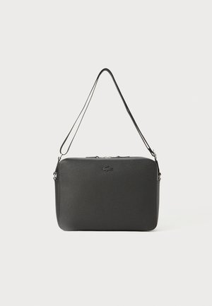 Black synthetic crossbody bag with a textured surface, zip closure, and adjustable strap. Features a subtle logo on the front.