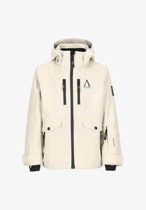 Beige skijakke med sorte detaljer, kombineret med sorte skibukser og støvler. Udstyret med hjelm og spejlglasbriller.