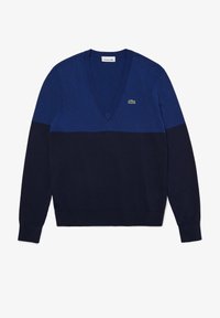 Mörkblå v-ringad tröja med en tvåfärgad design där den övre delen är ljusare blå. Ribbstickade cuffs och nederkant. Lacoste-logga på bröstet.