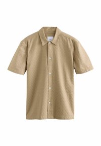 Chemise à manches courtes en tissu beige clair avec un motif texturé, dotée d'un col pointu et de boutons blancs sur le devant.