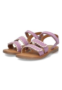 Paarse suède sandalen met drie brede banden met witte zigzagstiksels, open teen ontwerp en een platte bruine zool.