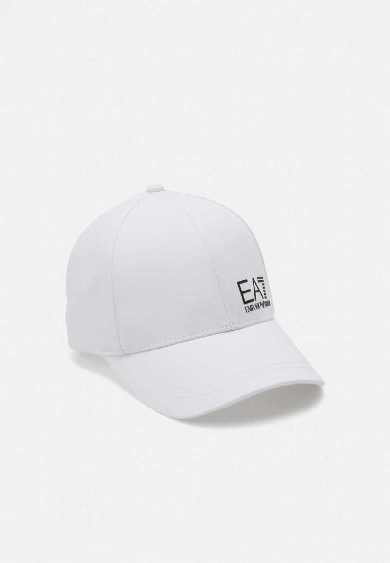 White baseball cap made of fabric with a curved brim. Features a black logo on the front reading "EA7 EMPORIO ARMANI."