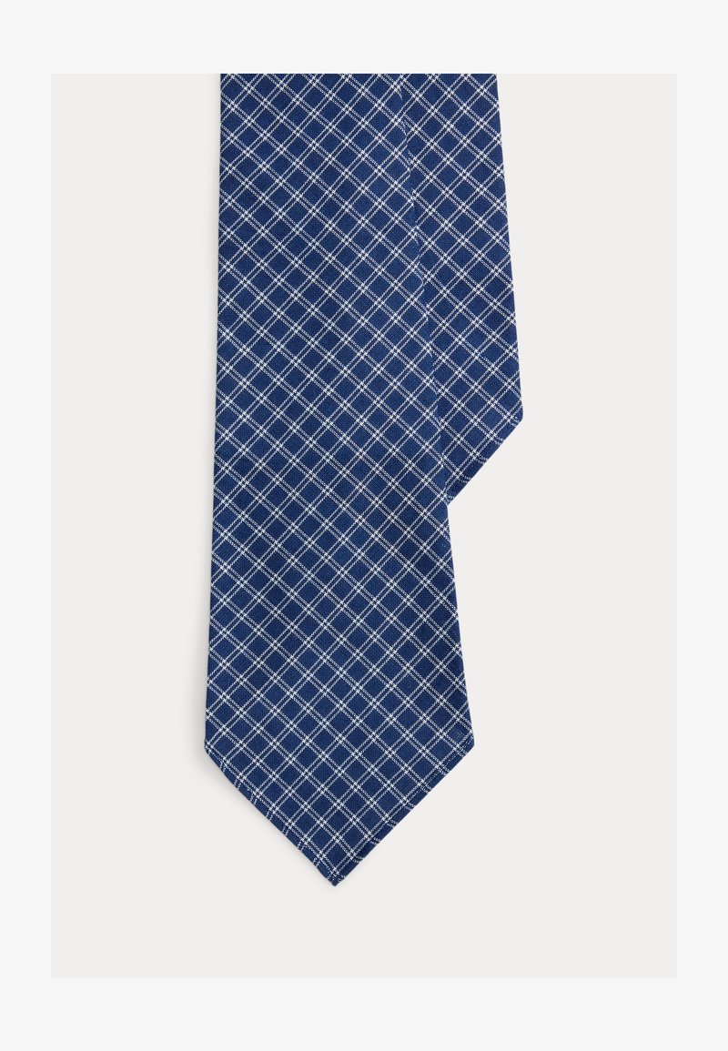 Γραβάτα σε ναυτικό μπλε με λευκό μοτίβο τετραγωνιδίων, εμφανιζόμενη σε απλό λευκό φόντο.