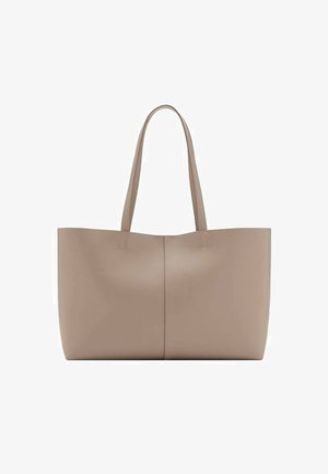 Large beige tote bag made of smooth leather. Features two long handles, seamless design, and a slight sheen. No visible hardware or patterns.