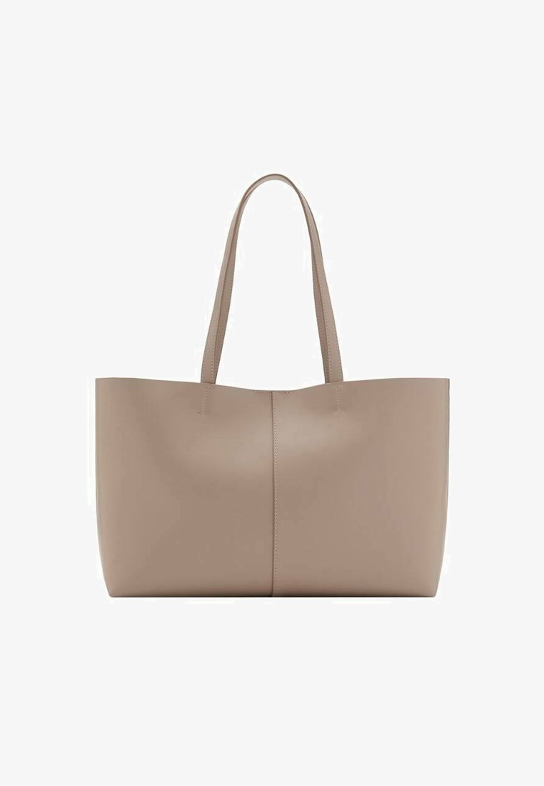 Large beige tote bag made of smooth leather. Features two long handles, seamless design, and a slight sheen. No visible hardware or patterns.