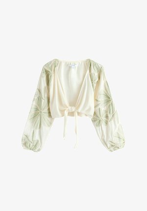 Krém színű, rövid fazonú blúz hosszú ballonujjakkal, zöld virágos hímzéssel és elöl megkötős rögzítéssel.