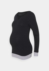 Zwarte lange mouwen zwangerschapsblouse met witte stippen, V-hals en gestreepte manchetten. Zacht materiaal met een aansluitende pasvorm.