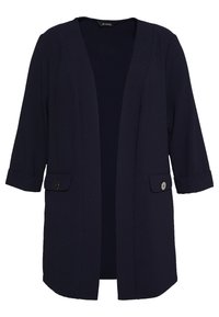 Veste bleu marine à ouverture avant en tissu texturé. Comprend des manches trois-quarts, deux poches avant et des boutons noirs en décoration.