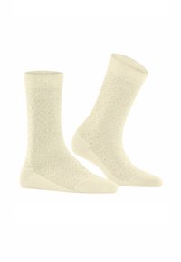 Knielange, hellcremefarbene Socken mit einem strukturierten Wabenmuster, gerippten Bündchen sowie verstärkten Zehen- und Fersenbereichen.