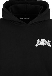 Juodas medvilnės džemperis su laisvu kirpimu, su ryškiu baltu "Lost Youth" logotipu žaismingu šriftu kairėje krūtinės pusėje.