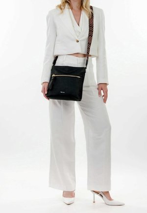 Black leather crossbody bag with a textured surface, gold zipper detail, and a patterned strap. Set against a light background.