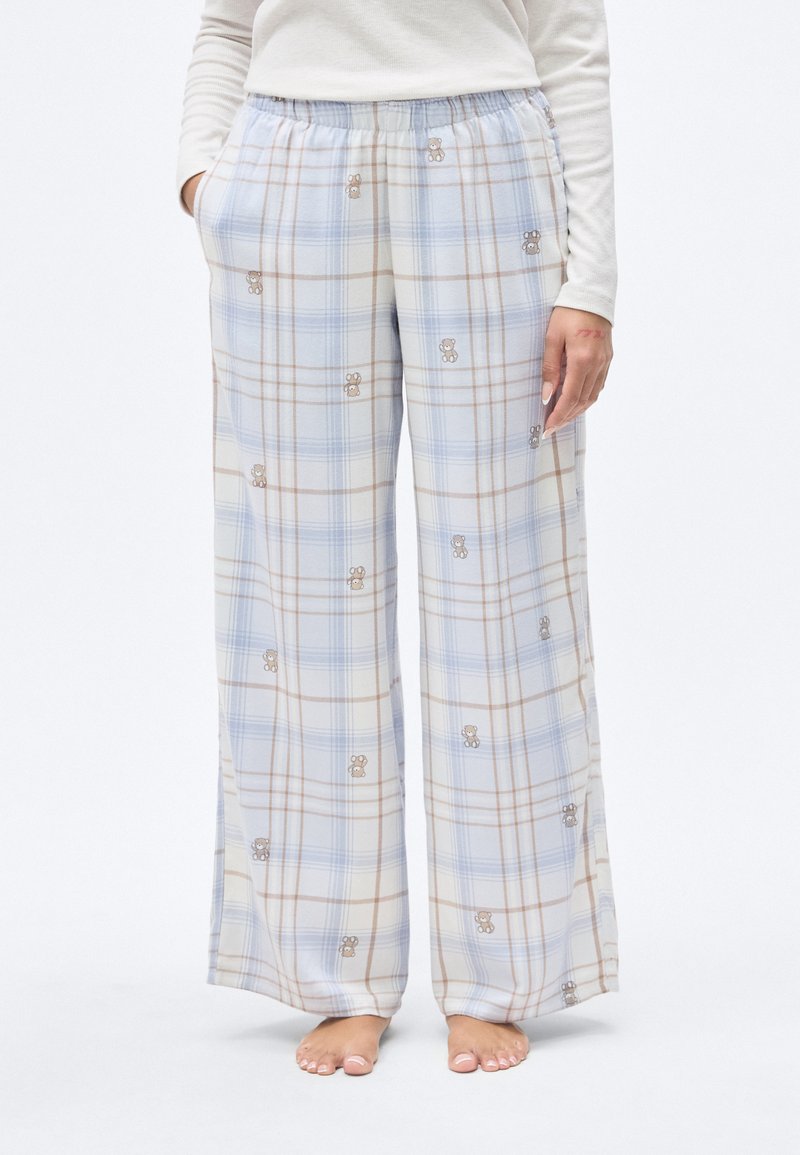 Ελαφρύ, καρό παντελόνι πιτζάμας σε μπλε και μπεζ με κεντημένες λεπτομέρειες αρκούδας. Διαθέτει ελαστική μέση και πλαϊνές τσέπες.