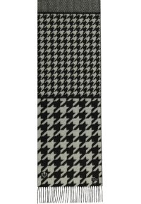 Kootud sall, millel on must-valge houndstooth muster, tekstuuriga pind ja äärtes trikitud narmad.