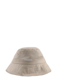 Beżowy kapelusz typu bucket wykonany z miękkiego materiału, z szerokim rondem i przeszyciami. Logo "PROSTO" nadrukowane na biało z przodu.