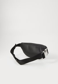 Black leather fanny pack with a textured surface, curved shape, adjustable nylon strap, and a silver metal buckle.