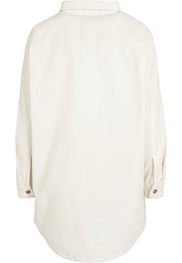 Chemise en velours côtelé blanc cassé à manches longues, avec poignets boutonnés et ourlet arrondi, vue de dos.