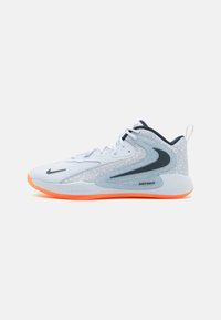 Athletic shoe with a white mesh upper, grey accents, and an orange rubber sole. Features a prominent swoosh and "JUST DO IT" branding.