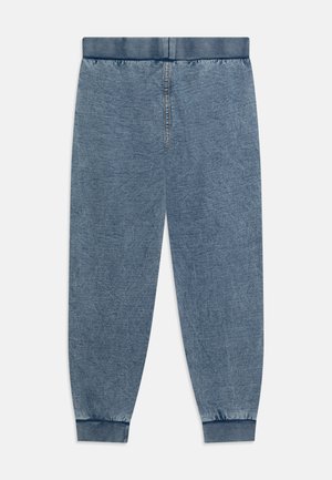 Light blue jogger pants, made of soft denim fabric, with an elastic waistband and cuffs tapering at the ankles. Features a smooth texture.