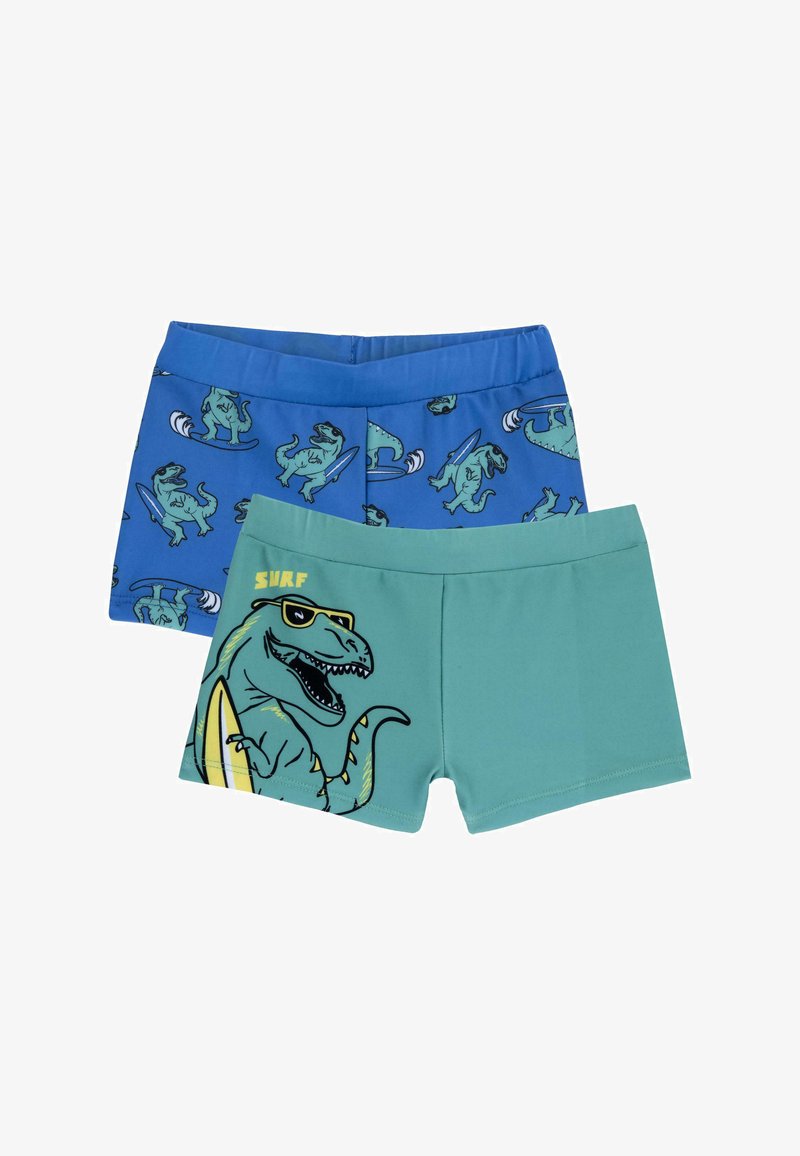 Zwei Paare Jungen-Schwimmshorts: eine blaue mit Dinosaurier-Surfmustern, eine grüne mit einem großen Dinosaurier-Graphic und dem Text "SURF".