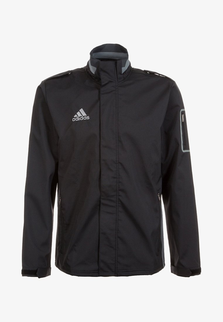 Veste noire Adidas avec col montant, poche poitrine zippée et logo sur la poitrine gauche, avec bordure réfléchissante sur la poche de la manche gauche.