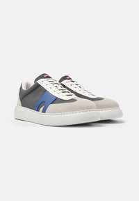Gray and blue sneaker with suede and fabric materials, white rubber sole, and contrasting lace panels. Red brand logo on the tongue.
