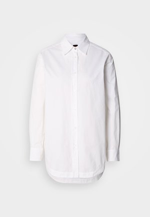 White button-up shirt with a collar, long sleeves, and a rounded hem. Made of cotton fabric with a smooth texture and subtle stitching detail.