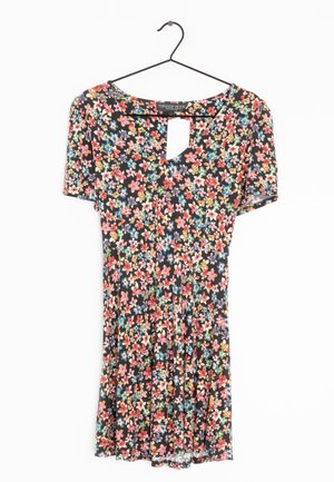Short-sleeve black dress with colorful small floral print, v-neck cutout, hanging on black hanger against white background.