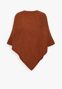 Rostfärgad poncho i strukturerad stickad tyg med diamantform och vid halsringning, som ger en lös och bekväm passform.
