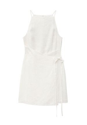 White sleeveless mini dress with high neckline, spaghetti straps, asymmetrical wrap design, and side tie detail.