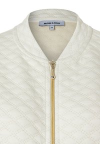 Weiße gesteppte Jacke mit goldenem Reißverschluss und rundem Kragen, Größe 36, Markenlabel "MORE & MORE" im Halsbereich sichtbar.