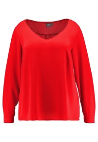 Czerwona bluzka z długim rękawem, dekoltem w serek, o luźnym kroju i lekko zaokrąglonych szwach ramion, oznaczona marką Zizzi.