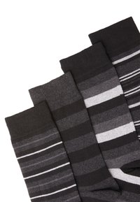 Four pairs of socks in shades of black and gray, featuring solid colors and stripes, with a knitted texture and ribbed cuffs.