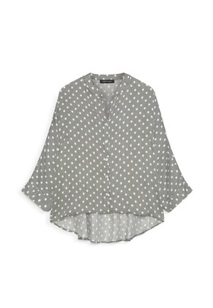 Langærmet knapbluse med sorte og hvide lodrette striber og hvide prikker, afslappet pasform med buet kant.