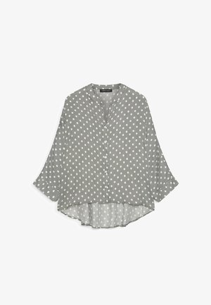 Bluza cu mâneci lungi și nasturi, cu dungi verticale negre și albe și model cu puncte albe, croială lejeră cu tiv curbat.