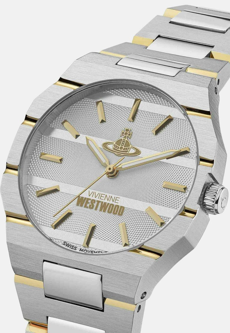 Silver watch with a textured dial, gold accents, and stainless steel strap. Features a round face and a crown on the side.
