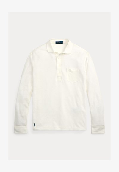 Hosszú ujjú póló krémszínű pamutból, háromgombos patenttal, mellzsebbel és tengerészkék logóval a szegélyen. Tiszta, minimalista dizájn.