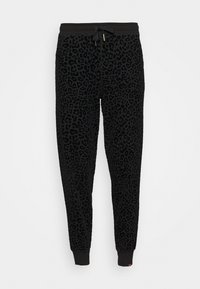 Svarta joggers i mjukt tyg med ett mönster av leopardfläckar, elastisk midja med snörning och avsmalnande muddar.